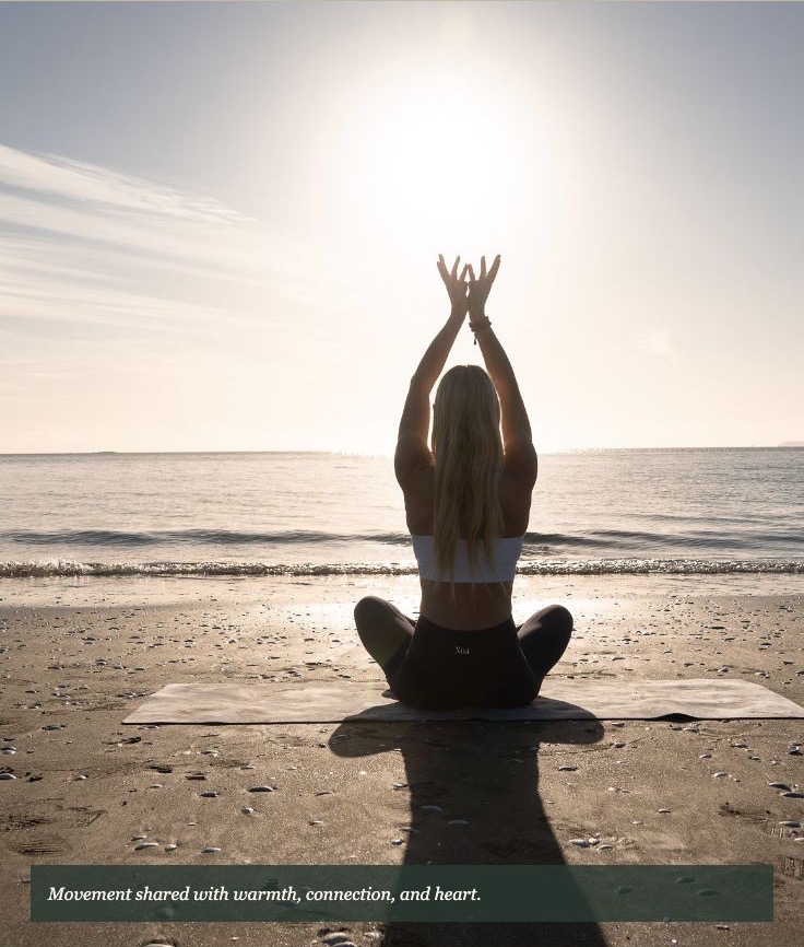 Aleasia practising yoga in the warm morning light beside the sea